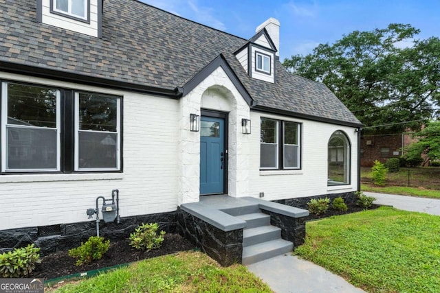1283 Beecher St SW, Atlanta, GA 30310 - view of front of home with brick siding, a chimney, a shingled roof, and a front lawn