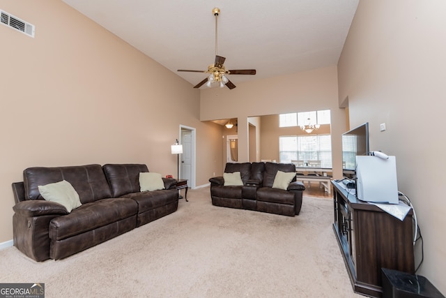 205 Carver Ct, Warner Robins, GA 31088 - living room featuring high vaulted ceiling, light colored carpet, ceiling fan, a chandelier, and baseboards