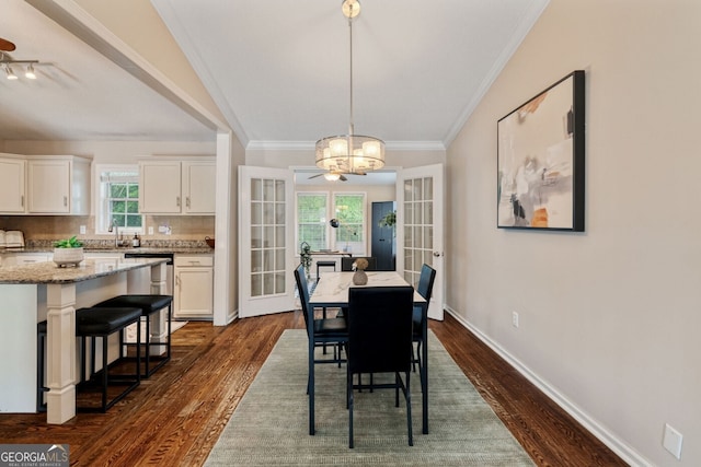 1087 Berkley Dr SE, Smyrna, GA 30082 - dining area featuring dark wood finished floors, a chandelier, healthy amount of natural light, ornamental molding, and baseboards