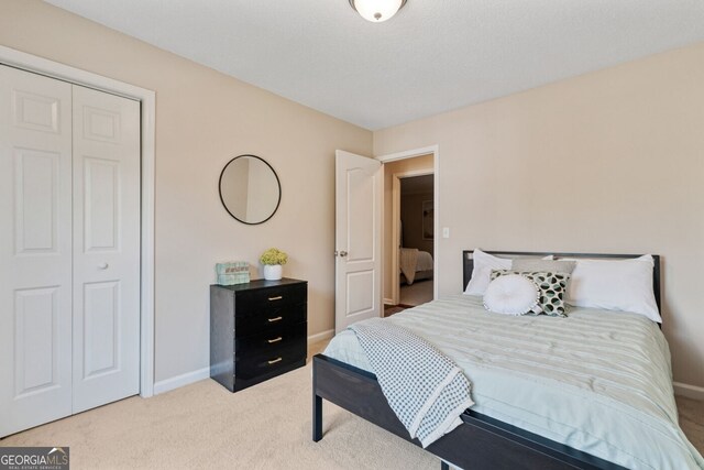 1087 Berkley Dr SE, Smyrna, GA 30082 - bedroom with baseboards, light carpet, and a closet