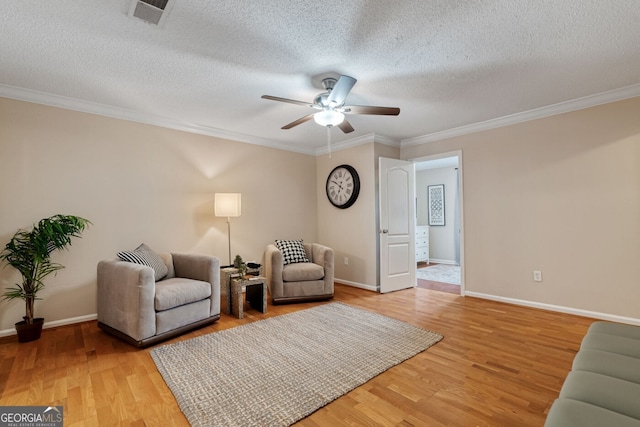 1087 Berkley Dr SE, Smyrna, GA 30082 - sitting room with a ceiling fan, crown molding, light wood-style floors, baseboards, and a textured ceiling