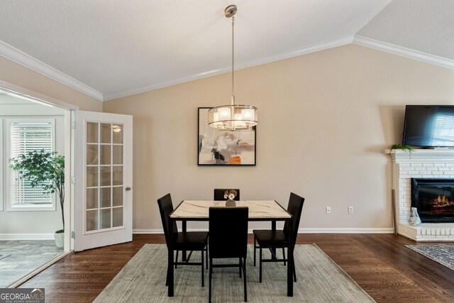 1087 Berkley Dr SE, Smyrna, GA 30082 - dining space with vaulted ceiling, crown molding, wood finished floors, baseboards, and a fireplace