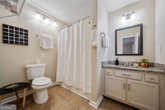 1087 Berkley Dr SE, Smyrna, GA 30082 - bathroom featuring vanity, toilet, tile patterned flooring, baseboards, and a textured ceiling