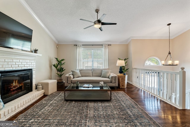 1087 Berkley Dr SE, Smyrna, GA 30082 - living area with ceiling fan, a textured ceiling, wood finished floors, a fireplace, and crown molding