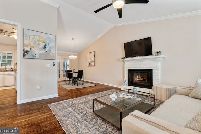 1087 Berkley Dr SE, Smyrna, GA 30082 - living area featuring wood finished floors, crown molding, ceiling fan, baseboards, and lofted ceiling