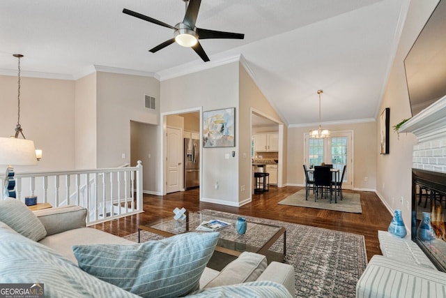 1087 Berkley Dr SE, Smyrna, GA 30082 - living area featuring a chandelier, wood finished floors, ceiling fan, baseboards, and high vaulted ceiling