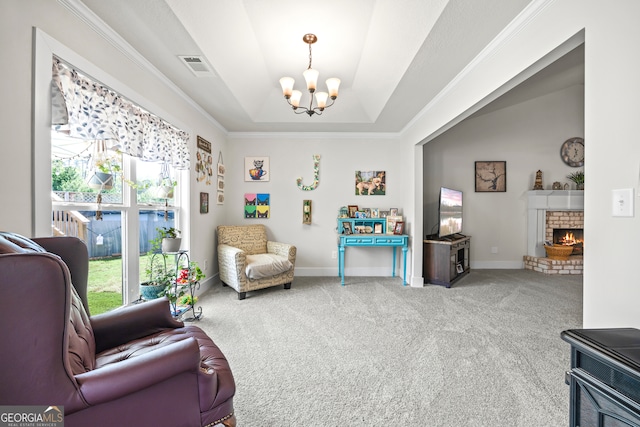 290 Bowers Estates Dr, Hartwell, GA 30643 - living area featuring a chandelier, carpet flooring, crown molding, a tray ceiling, and a brick fireplace