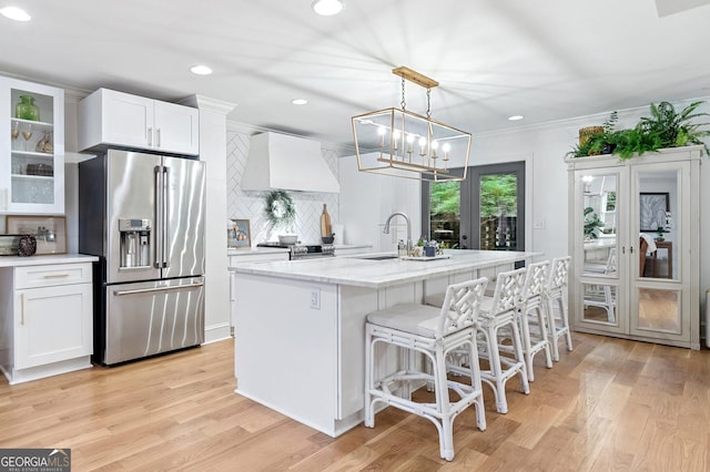 70 Old Ivy Rd NE Unit 57, Atlanta, GA 30342 - kitchen with high end fridge, custom exhaust hood, decorative backsplash, white cabinets, and light wood-type flooring