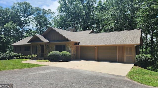 232 Fenwick Wood, Clarkesville, GA 30523 - view of front of house featuring stone siding, a garage, concrete driveway, a chimney, and a front lawn