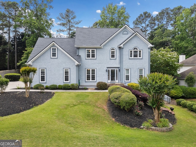 5711 Brynwood Cir NW, Acworth, GA 30101 - view of front of house with a front yard, a shingled roof, and stucco siding