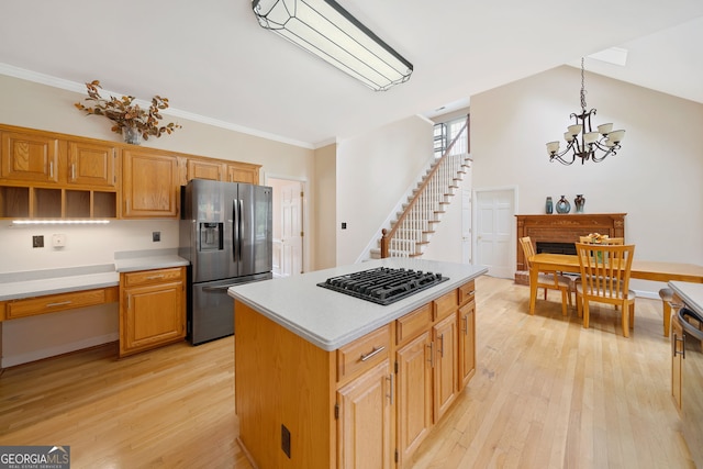 5711 Brynwood Cir NW, Acworth, GA 30101 - kitchen featuring stainless steel fridge with ice dispenser, black gas stovetop, light wood-style floors, a chandelier, and crown molding