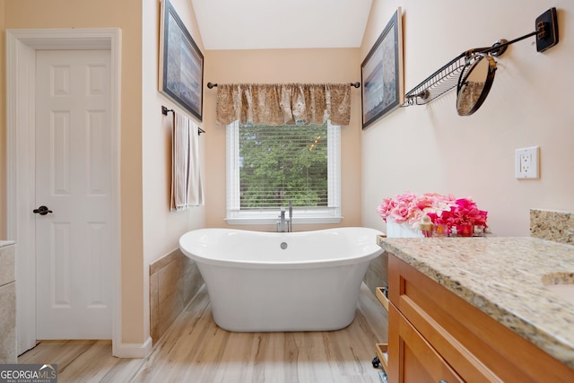 5711 Brynwood Cir NW, Acworth, GA 30101 - full bathroom featuring wood finished floors, a soaking tub, and vanity
