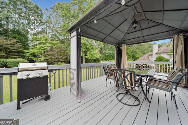5711 Brynwood Cir NW, Acworth, GA 30101 - deck featuring a gazebo, a grill, outdoor dining area, and view of wooded area