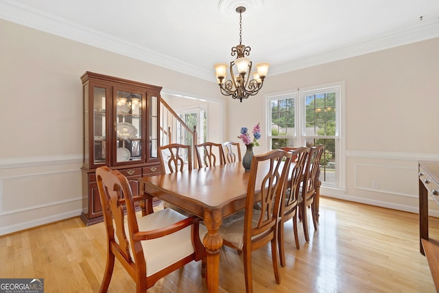 5711 Brynwood Cir NW, Acworth, GA 30101 - dining room with a chandelier, crown molding, light wood finished floors, and wainscoting