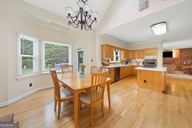 5711 Brynwood Cir NW, Acworth, GA 30101 - dining room featuring light wood-style floors, a chandelier, baseboards, a towering ceiling, and crown molding