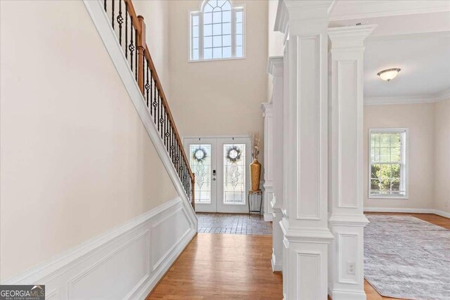 3113 Brians Creek Dr SE, Conyers, GA 30013 - foyer featuring stairs, crown molding, light wood-type flooring, and a high ceiling