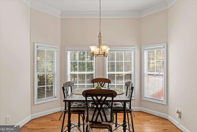 3113 Brians Creek Dr SE, Conyers, GA 30013 - dining room featuring a chandelier, crown molding, and light wood-type flooring