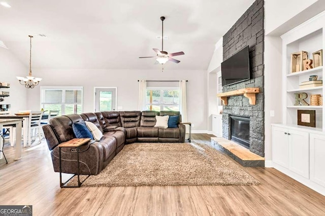 2980 Beards Rd, Buford, GA 30518 - living area with vaulted ceiling, a chandelier, wood finished floors, a fireplace, and ceiling fan