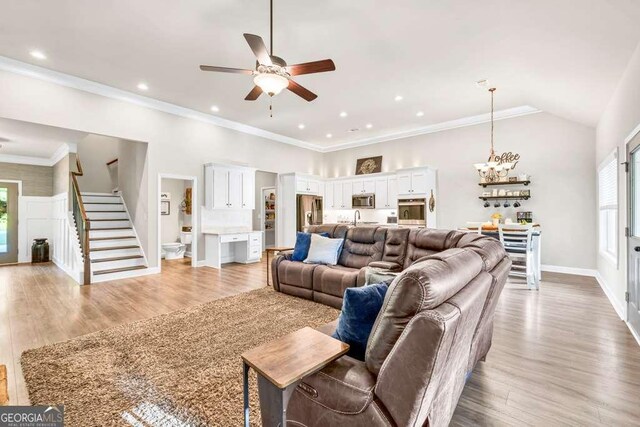 2980 Beards Rd, Buford, GA 30518 - living room featuring stairs, a chandelier, a ceiling fan, light wood finished floors, and recessed lighting