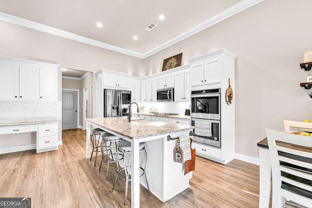 2980 Beards Rd, Buford, GA 30518 - kitchen featuring stainless steel appliances, ornamental molding, a breakfast bar, white cabinets, and recessed lighting