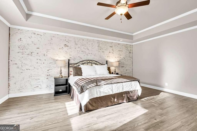 2980 Beards Rd, Buford, GA 30518 - bedroom with an accent wall, a raised ceiling, wood finished floors, wallpapered walls, and ornamental molding
