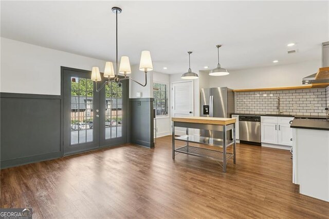 355 Winding River Dr Unit B, Atlanta, GA 30350 - kitchen with appliances with stainless steel finishes, dark countertops, open shelves, tasteful backsplash, and dark wood finished floors