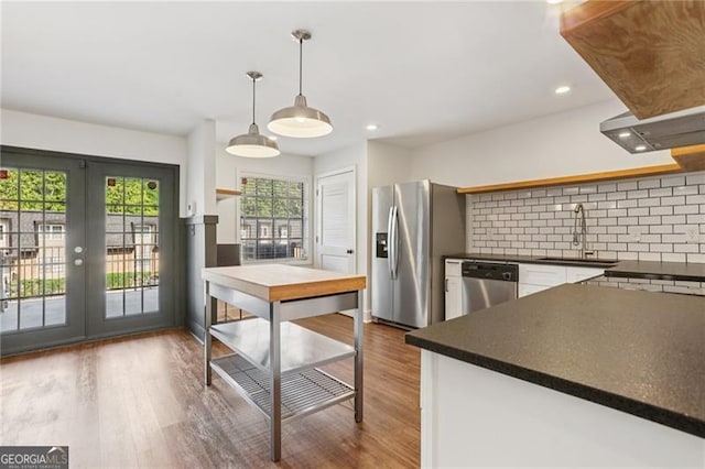355 Winding River Dr Unit B, Atlanta, GA 30350 - kitchen with open shelves, appliances with stainless steel finishes, dark countertops, backsplash, and wood finished floors