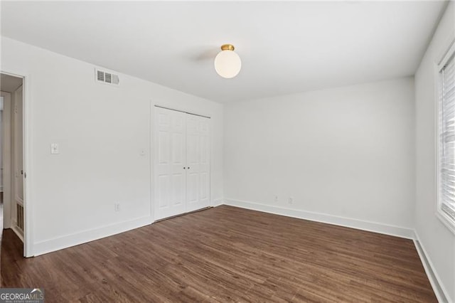 355 Winding River Dr Unit B, Atlanta, GA 30350 - unfurnished bedroom with dark wood-style flooring and a closet