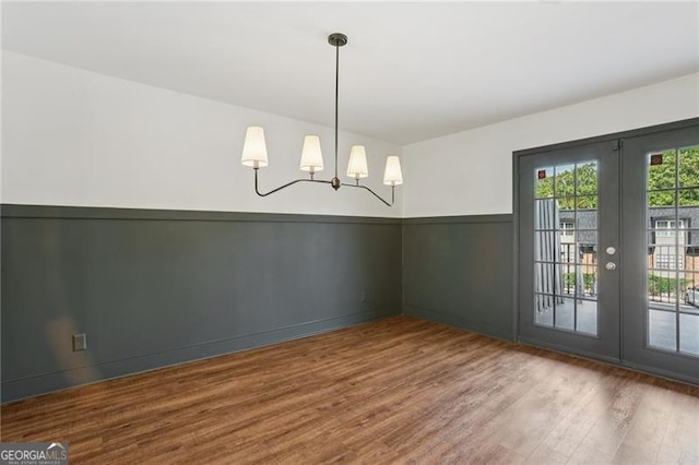 355 Winding River Dr Unit B, Atlanta, GA 30350 - empty room featuring wood finished floors, french doors, a chandelier, and wainscoting