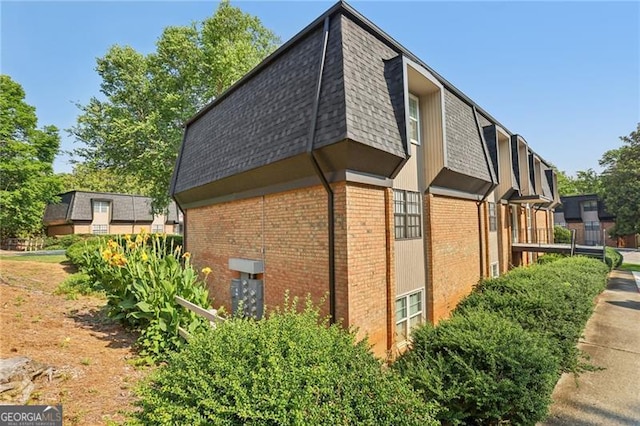 355 Winding River Dr Unit B, Atlanta, GA 30350 - view of home's exterior featuring brick siding, a shingled roof, and mansard roof