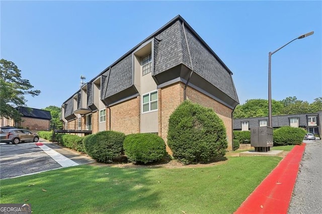 355 Winding River Dr Unit B, Atlanta, GA 30350 - view of side of property featuring mail area, mansard roof, brick siding, and a shingled roof