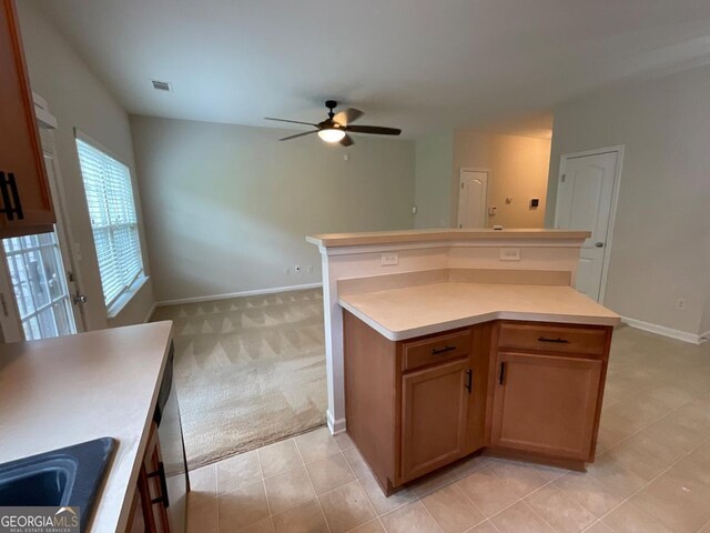 6941 Rogers Pt, Lithonia, GA 30058 - kitchen with a ceiling fan, baseboards, light countertops, light tile patterned flooring, and light colored carpet