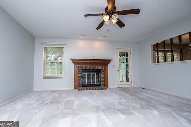 65 Pine Haven Ct, Carrollton, GA 30116 - unfurnished living room featuring carpet, plenty of natural light, baseboards, and a brick fireplace