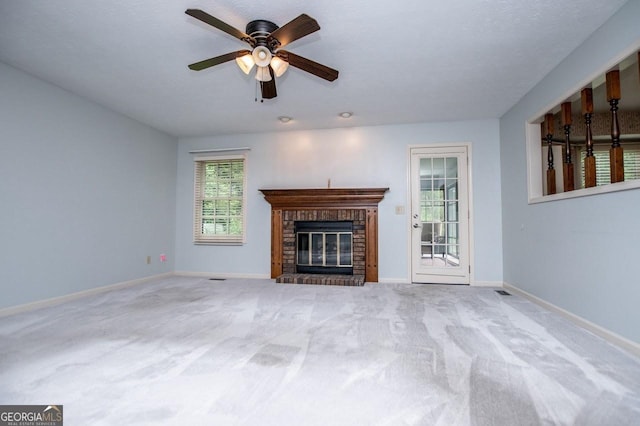 65 Pine Haven Ct, Carrollton, GA 30116 - unfurnished living room with carpet floors, baseboards, a brick fireplace, and ceiling fan
