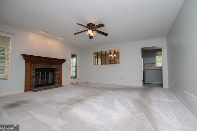 65 Pine Haven Ct, Carrollton, GA 30116 - unfurnished living room featuring ceiling fan, a fireplace, plenty of natural light, and carpet floors