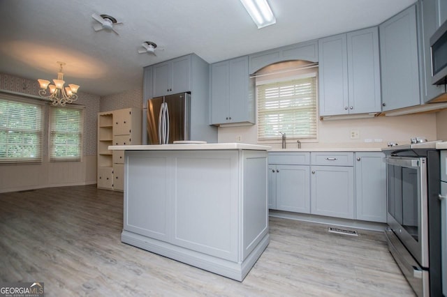 65 Pine Haven Ct, Carrollton, GA 30116 - kitchen featuring appliances with stainless steel finishes, a chandelier, healthy amount of natural light, and light countertops