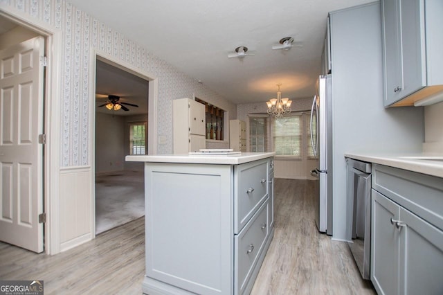 65 Pine Haven Ct, Carrollton, GA 30116 - kitchen with wallpapered walls, gray cabinets, light wood finished floors, and a chandelier