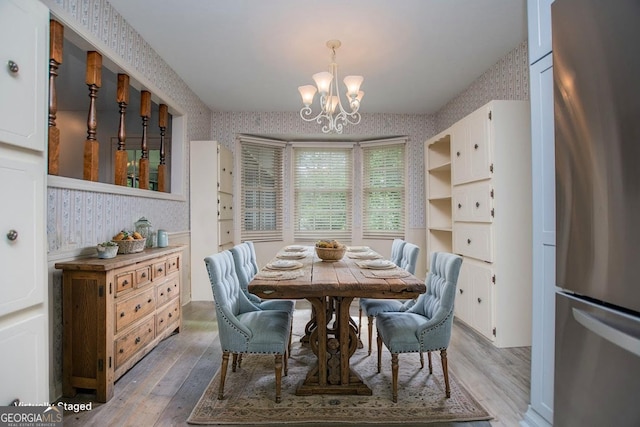 65 Pine Haven Ct, Carrollton, GA 30116 - dining room with wallpapered walls, a chandelier, and light wood-style flooring