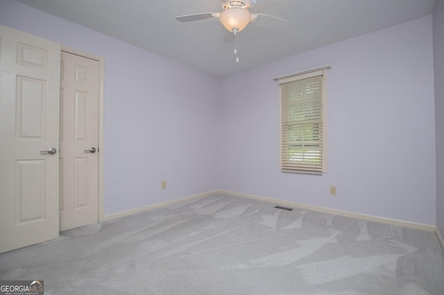 65 Pine Haven Ct, Carrollton, GA 30116 - spare room featuring light colored carpet, a ceiling fan, and baseboards