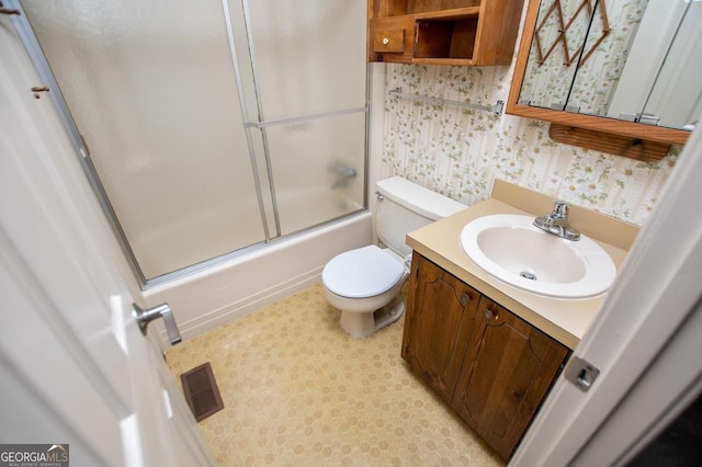 65 Pine Haven Ct, Carrollton, GA 30116 - full bath featuring vanity, toilet, enclosed tub / shower combo, and wallpapered walls