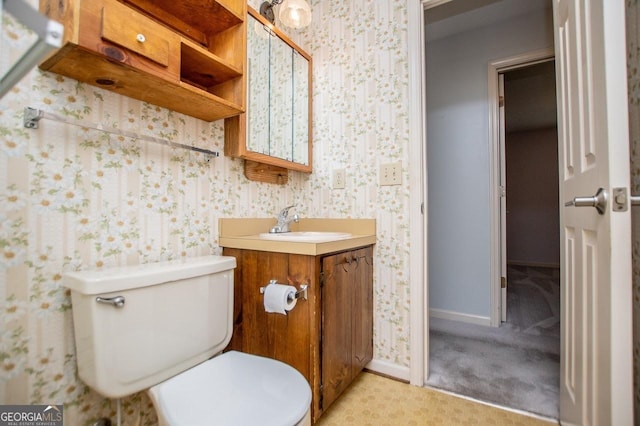 65 Pine Haven Ct, Carrollton, GA 30116 - bathroom featuring toilet, wallpapered walls, vanity, and baseboards