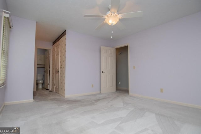 65 Pine Haven Ct, Carrollton, GA 30116 - unfurnished bedroom featuring carpet flooring, baseboards, connected bathroom, and ceiling fan
