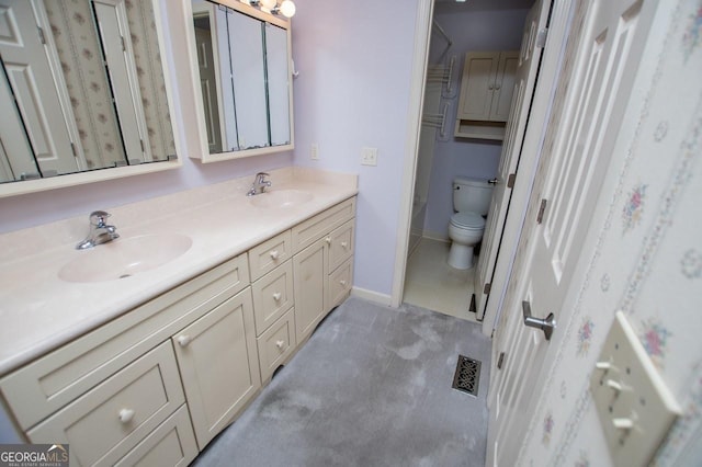 65 Pine Haven Ct, Carrollton, GA 30116 - bathroom with double vanity, toilet, and baseboards