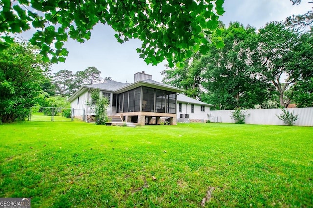 65 Pine Haven Ct, Carrollton, GA 30116 - rear view of property featuring a sunroom and a chimney