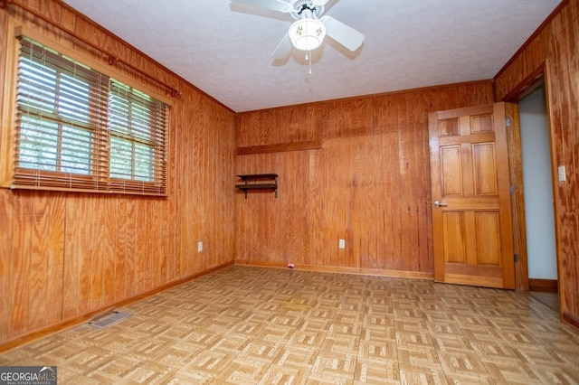 65 Pine Haven Ct, Carrollton, GA 30116 - unfurnished room with wood walls, baseboards, ceiling fan, and a textured ceiling