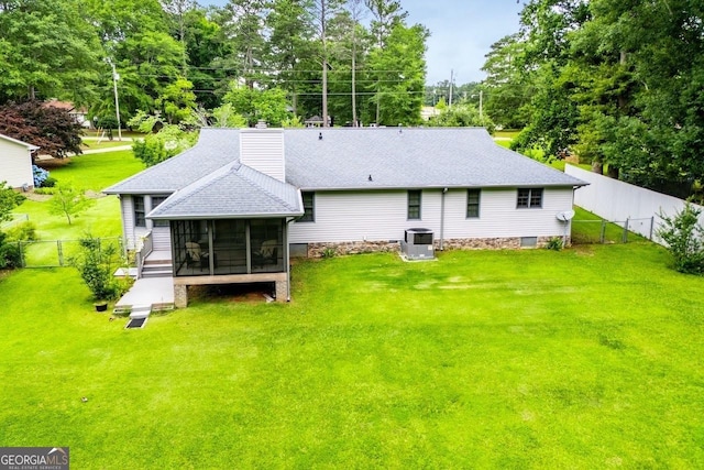 65 Pine Haven Ct, Carrollton, GA 30116 - back of property featuring a sunroom, cooling unit, roof with shingles, a chimney, and view of wooded area