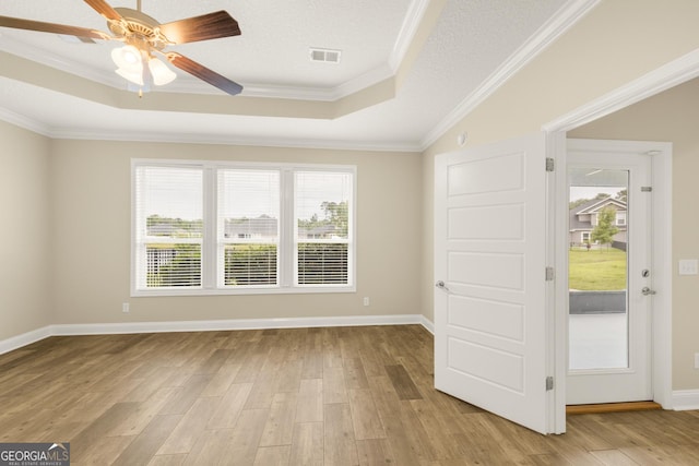 308 Laurel Landing Blvd, Kingsland, GA 31548 - spare room featuring a tray ceiling, crown molding, light wood-type flooring, a ceiling fan, and baseboards