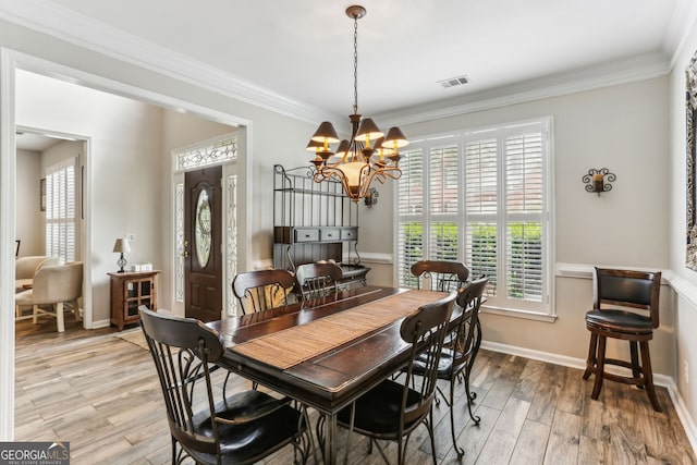 2624 E Madison Dr, Atlanta, GA 30360 - dining space with crown molding, a chandelier, light wood-style flooring, and baseboards