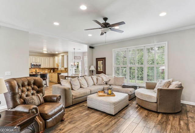 2624 E Madison Dr, Atlanta, GA 30360 - living area featuring a chandelier, wood finished floors, recessed lighting, a ceiling fan, and crown molding