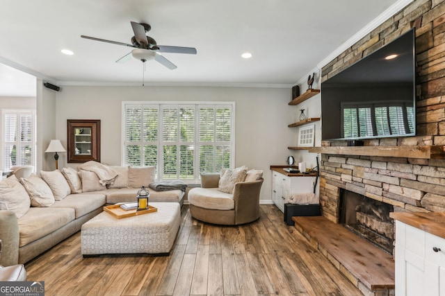 2624 E Madison Dr, Atlanta, GA 30360 - living area featuring hardwood / wood-style flooring, a ceiling fan, ornamental molding, healthy amount of natural light, and a stone fireplace